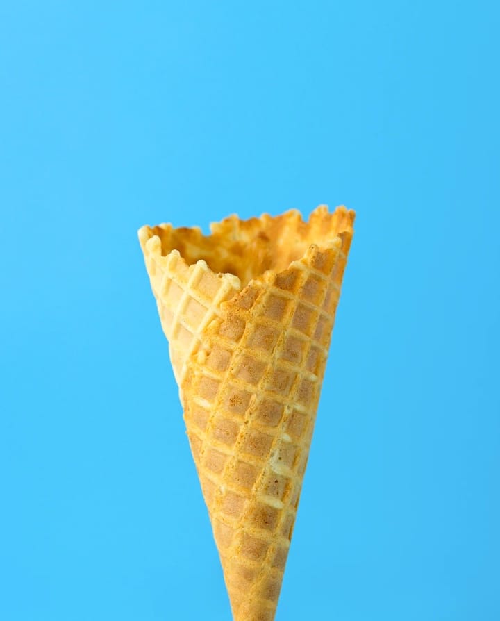 An ice-cream cone on blue background