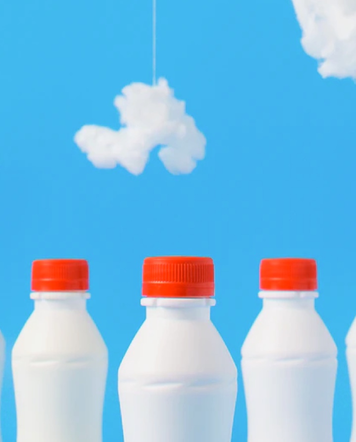 White bottles with red caps on blue background