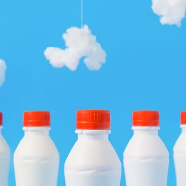 White bottles with red caps on blue background